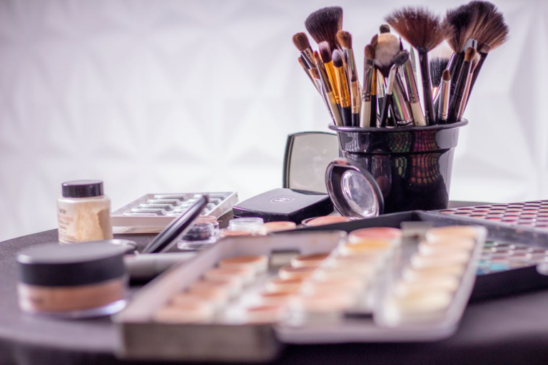 Make up brushes along with other makeup products on the table